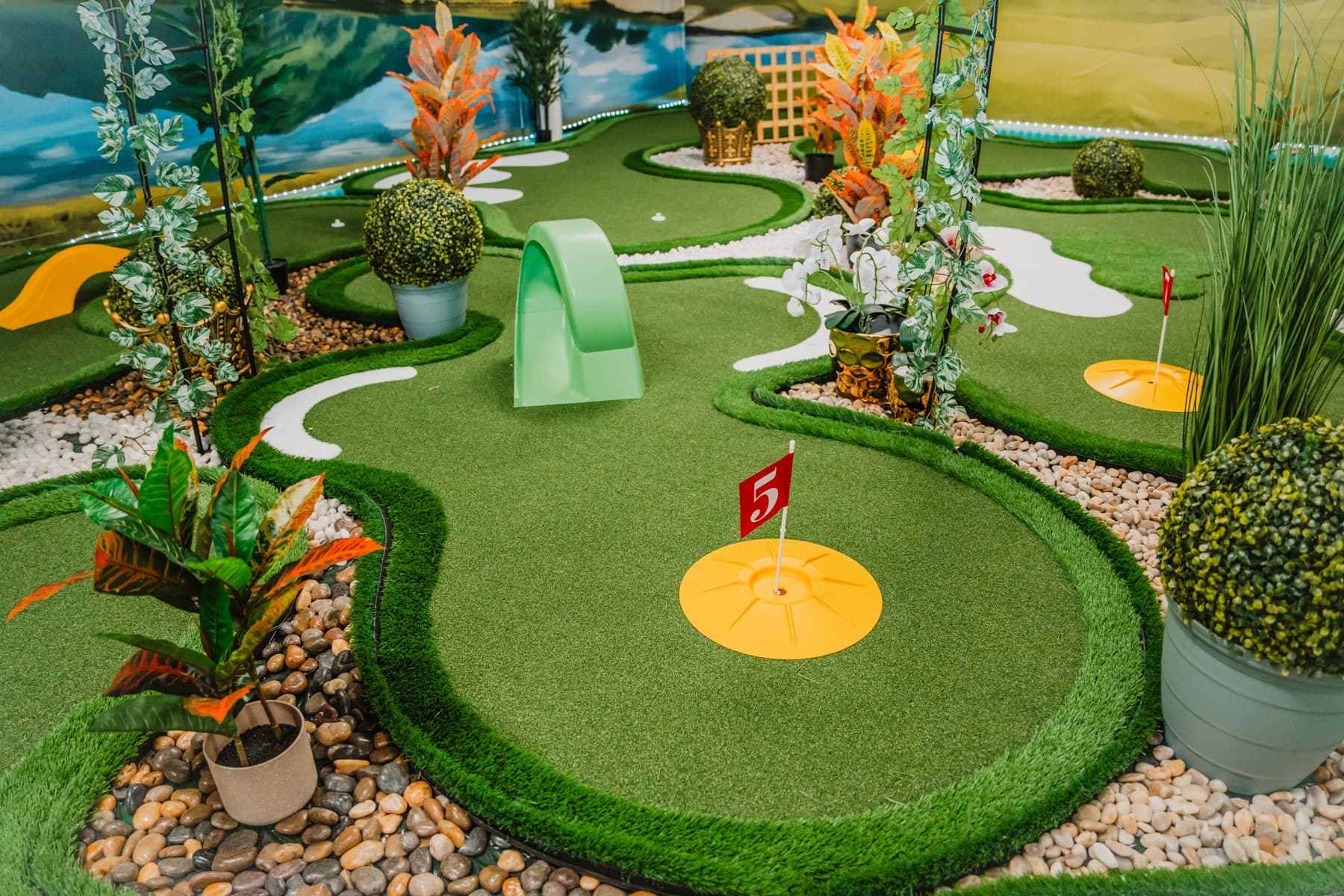 Photograph of the real mint-green loop obstacle and numbered red flags