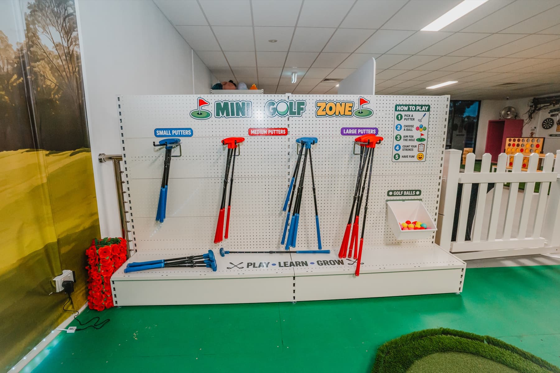 Photograph of the real mini golf putter and colourful ball station